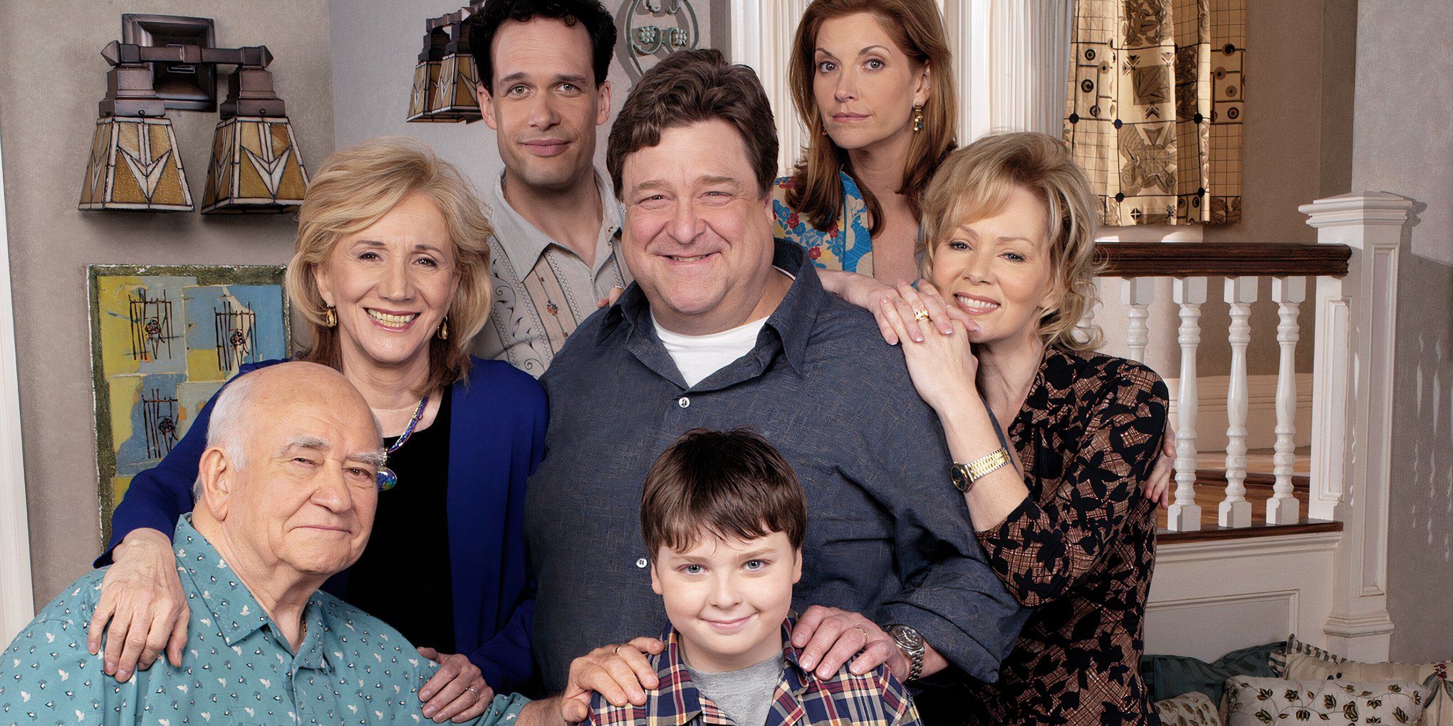 The family of The Center of the Universe posing for a photo in front of their staircase