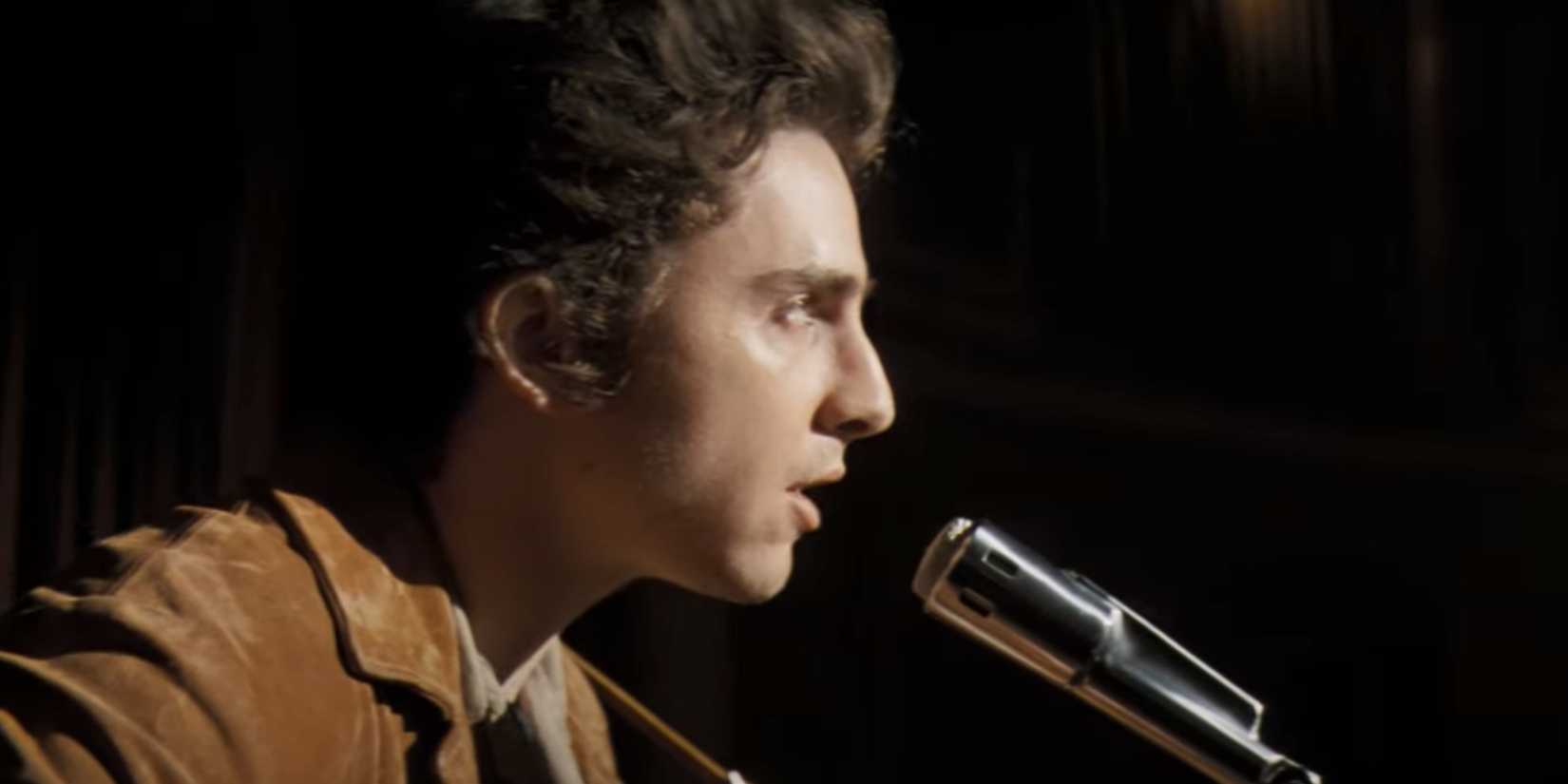 Timothee Chalamet as Bob Dylan singing in A Complete Unknown