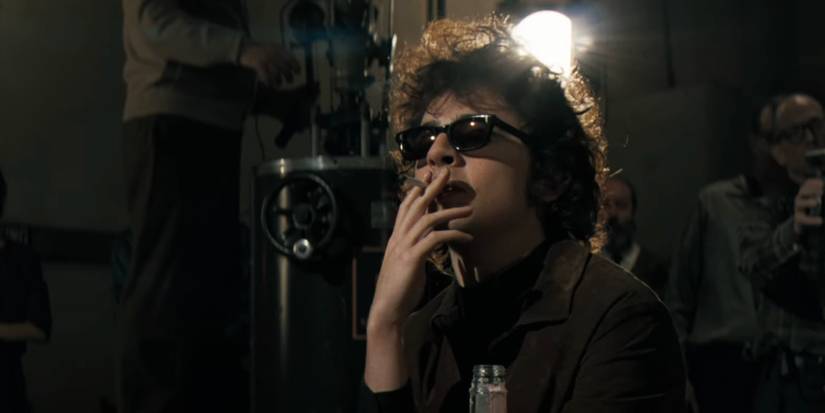 Timothee Chalamet smoking a cigarette as Bob Dylan in A Complete Unknown
