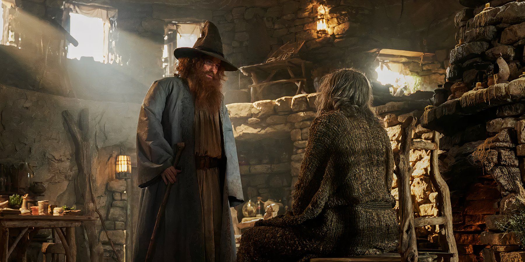 Tom Bombadil (Rory Kinnear) looks down on the Stranger (Daniel Weyman) in The Lord of the Rings, Season 2 of the Rings of Power