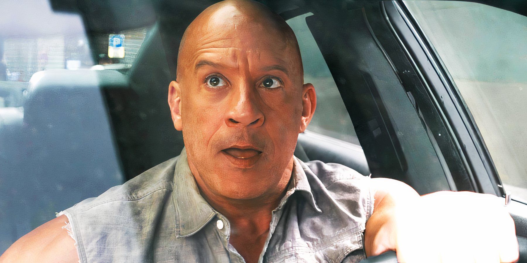 Vin Diesel as Dom Toretto looking in the rearview mirror in Fast X