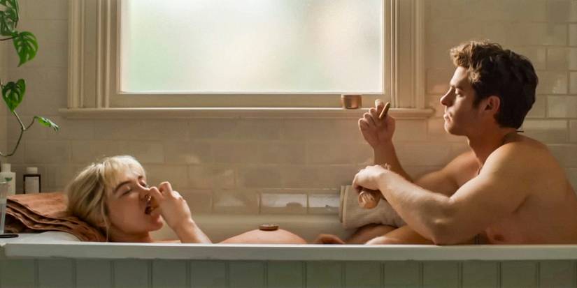 In a bathtub, pregnant Almut (Florence Pugh) is having a good time with Tobias (Andrew Garfield) in We Live in Time