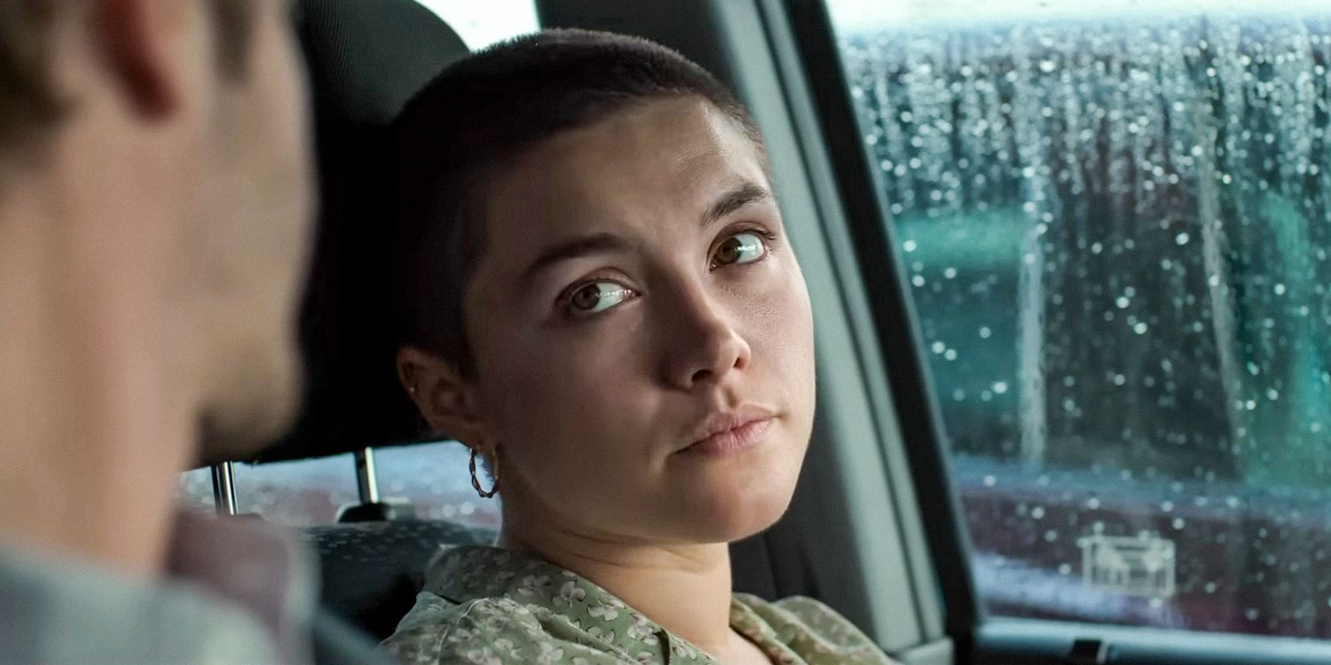 Almut (Florence Pugh) with a shaved head looks sad in We Live in Time