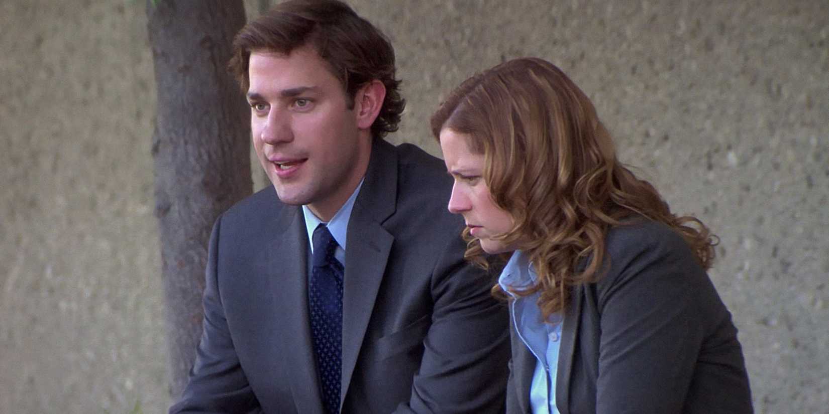Jim and Pam are sitting on a bench outside the office in The Office