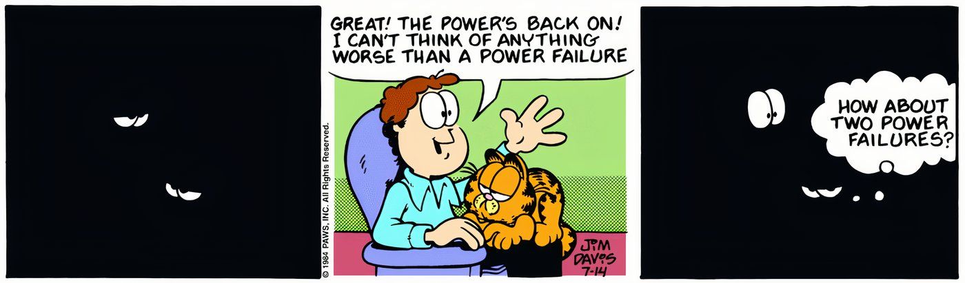 Garfield e Jon sentados juntos quando a energia em sua casa é ligada e desligada novamente.