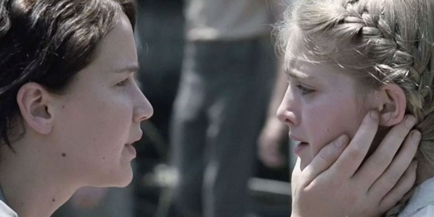 Katniss holds Prim at Reaping in the opening scene of The Hunger Games.