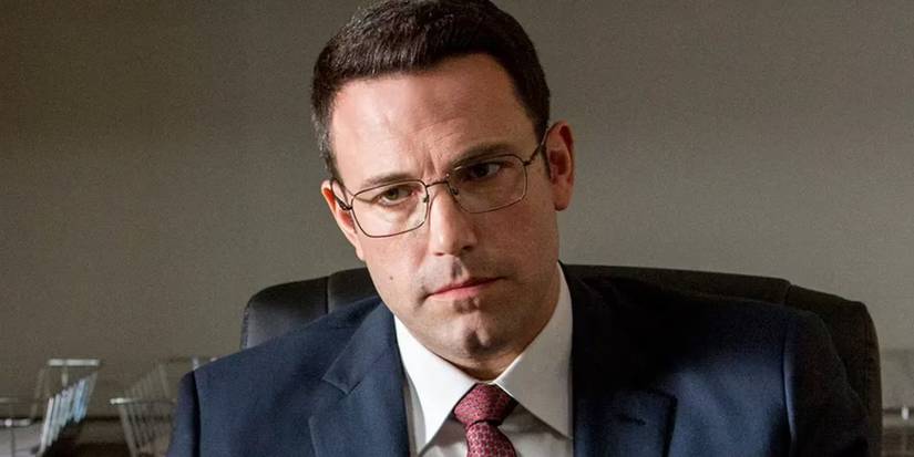 Ben Affleck as Christian Wolff wearing a suit and glasses in The Accountant