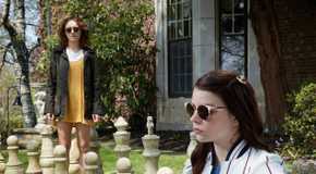 Anya Taylor-Joy and Olivia Cooke in a garden in Thoroughbreds