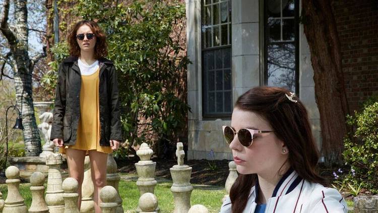 Anya Taylor-Joy and Olivia Cooke in a garden in Thoroughbreds
