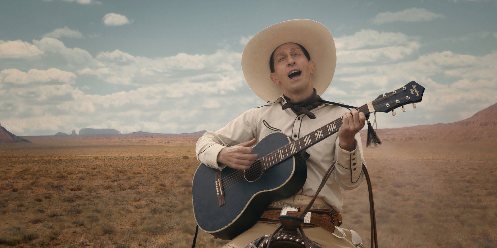 Tim Blake Nelson playing guitar and singing in The Ballad of Buster Scruggs