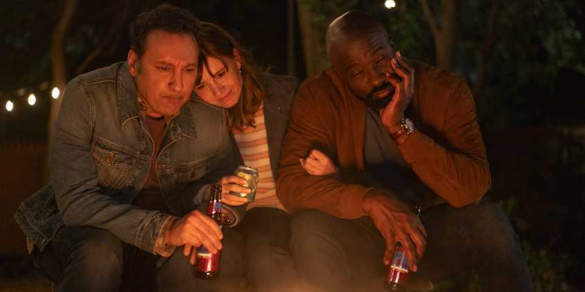 Ben, Kristen and David hold each other in front of the bonfire in Evil series finale