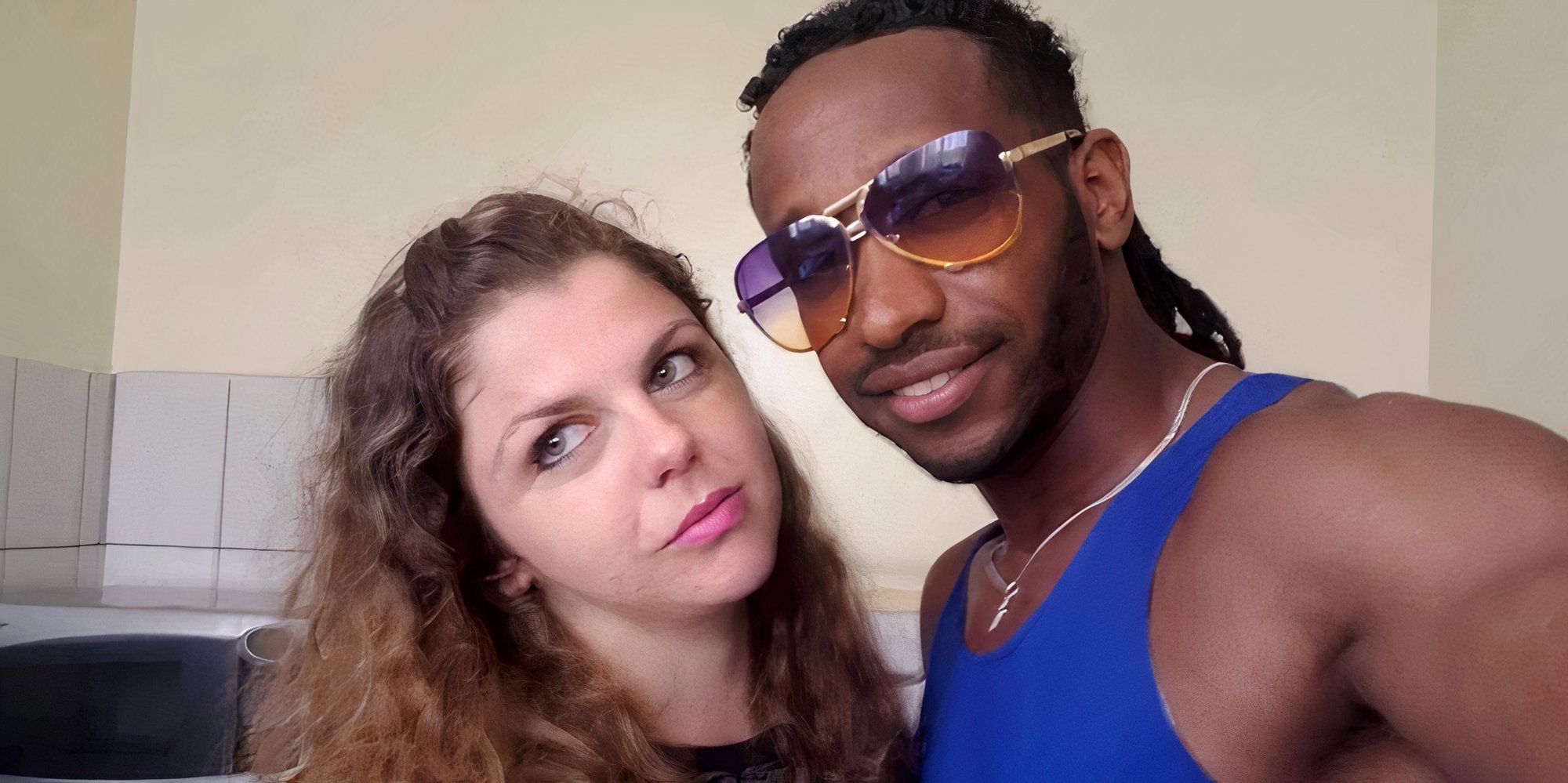 Biniyam in blue tank top and Ariela in 90 Day Fiance taking a selfie together 