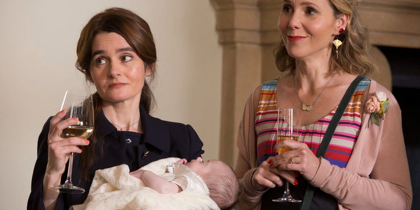 Jude holds her baby and glass of wine in Bridget Jones' Baby