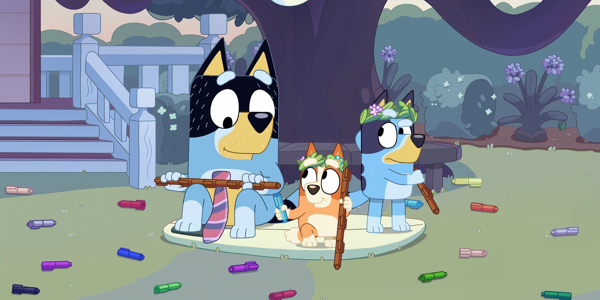 Bluey, Bingo, and Bandit sit on Rug Island by the tree in the Rug Island episode of Bluey