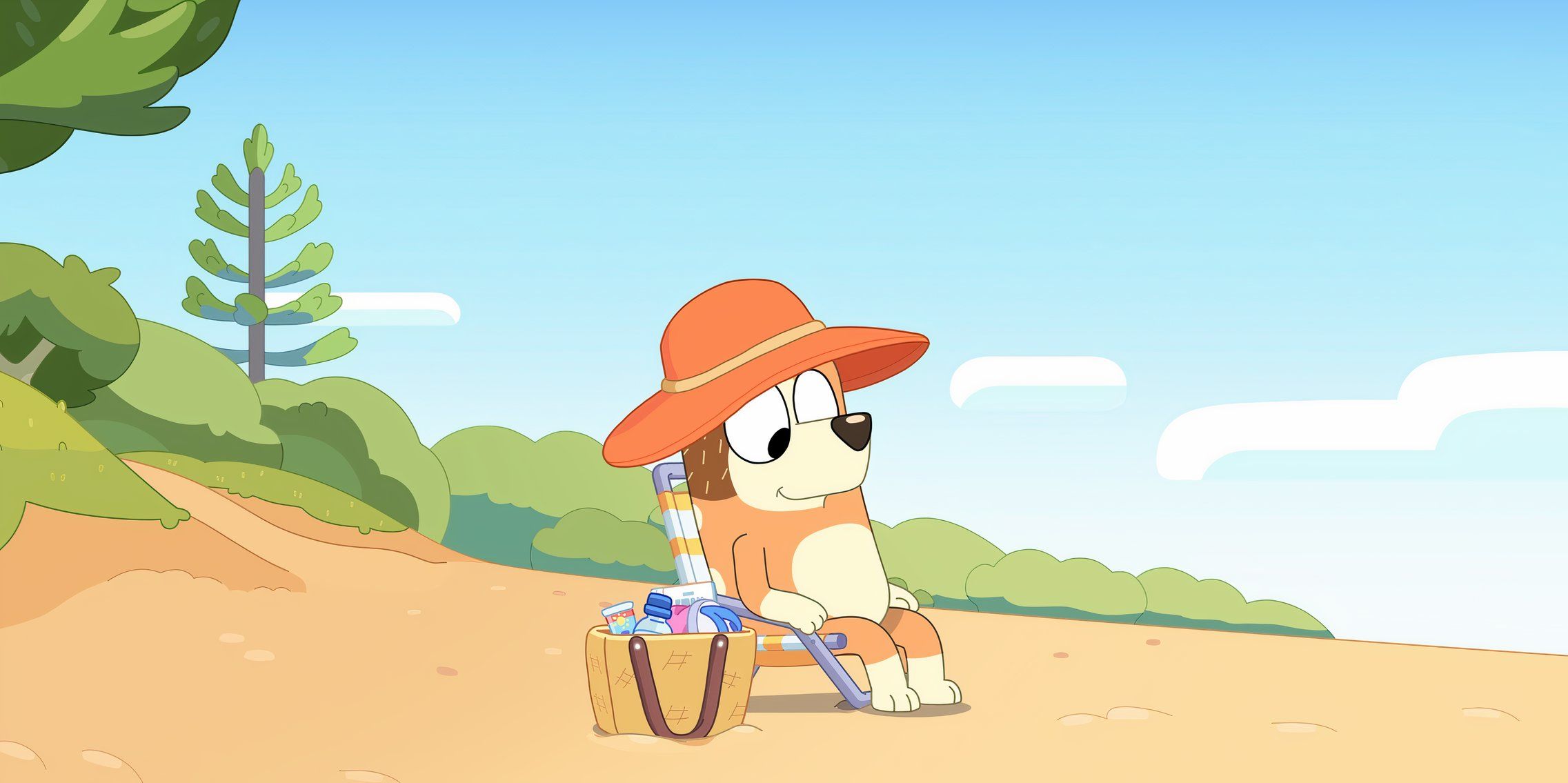 Chilli sits on the beach in Bluey