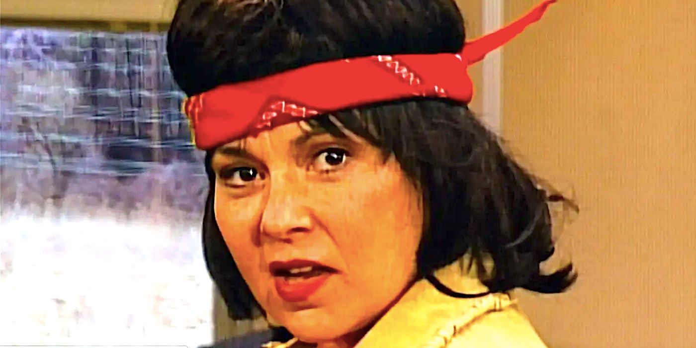 Close up of Roseanne Barr's Roseanne dressed as Rambo on a train in Roseambo Roseanne season 9 episode 9-1