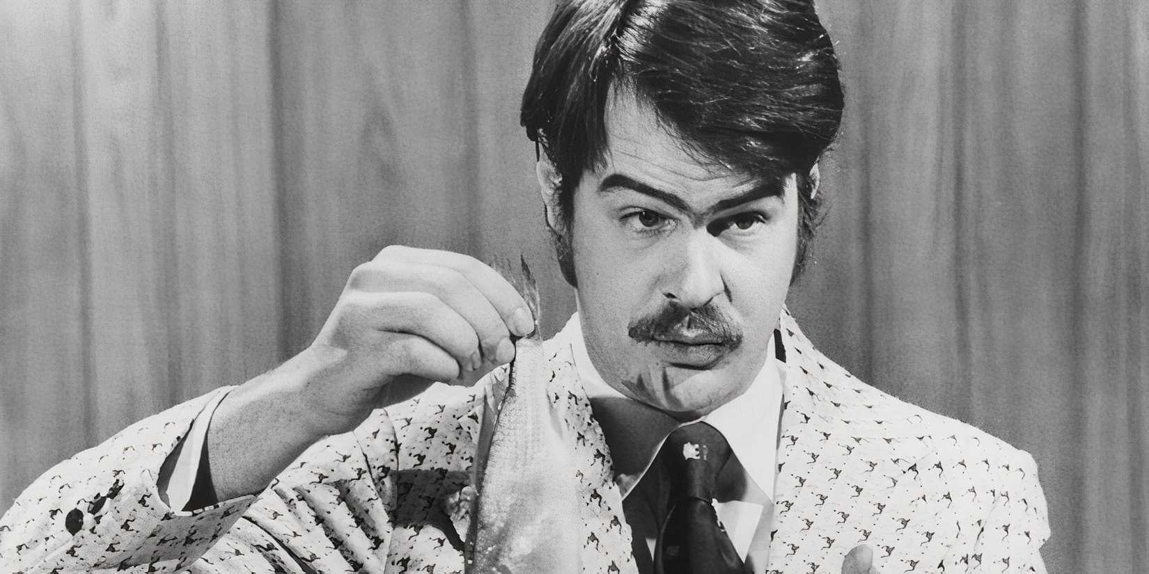 Dan Aykroyd holding a fish on Saturday Night Live