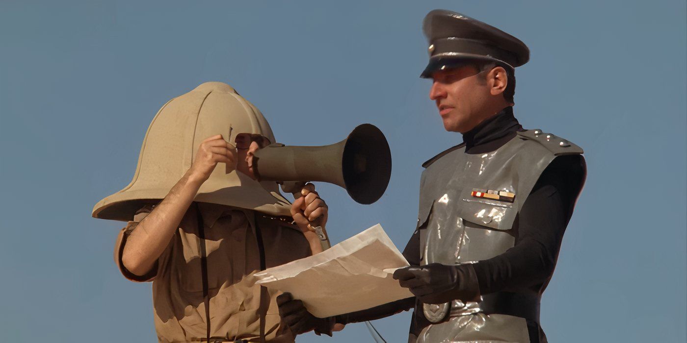 Darth Helmet yelling into a bullhorn at Col Sandurz in Spaceballs