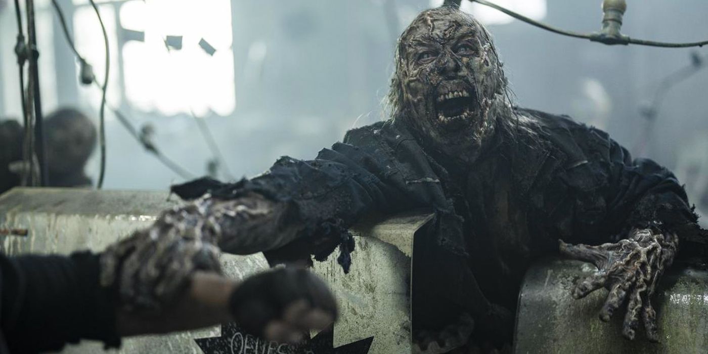 A zombie with acidic skin grabbing Daryl&rsquo;s (Norman Reedus) arm in The Walking Dead: Daryl Dixon