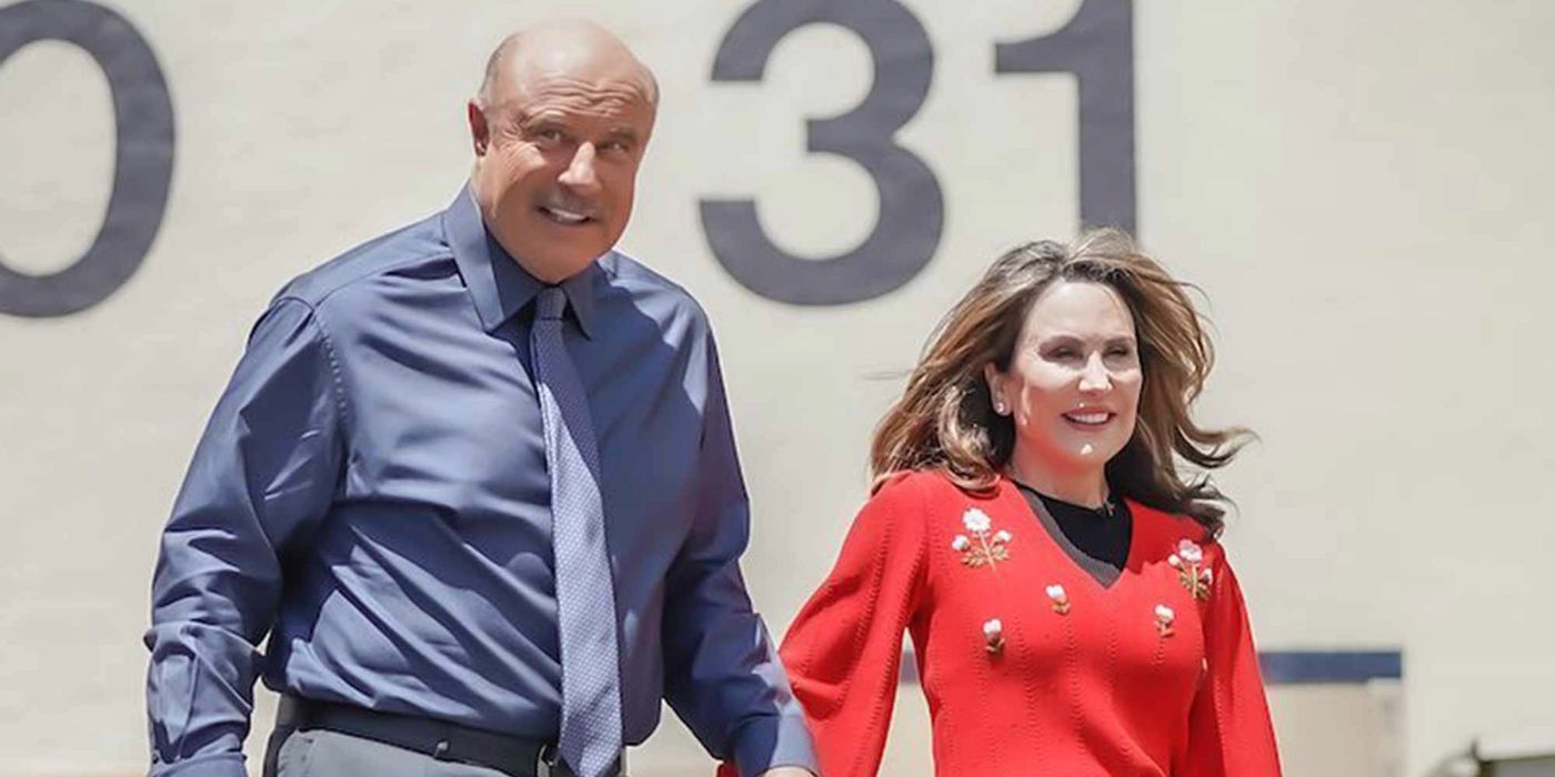 Robin McGraw and Phil McGraw smiling in the sun