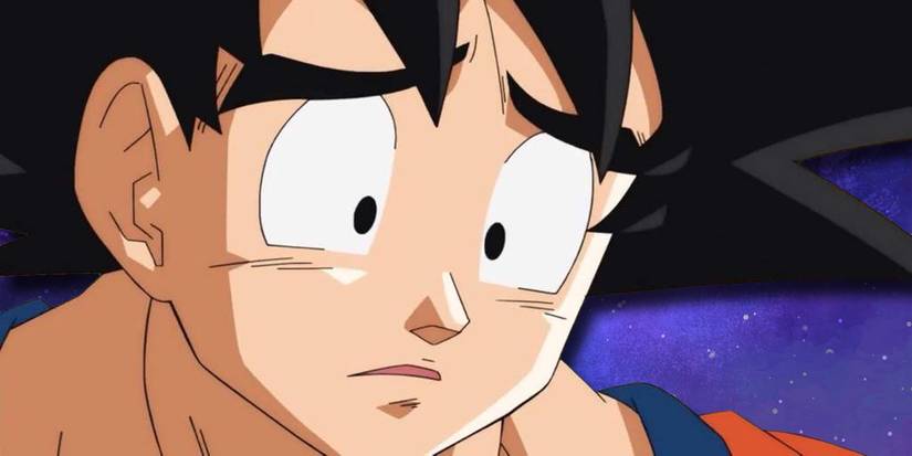 Goku looking sad on a starry background.