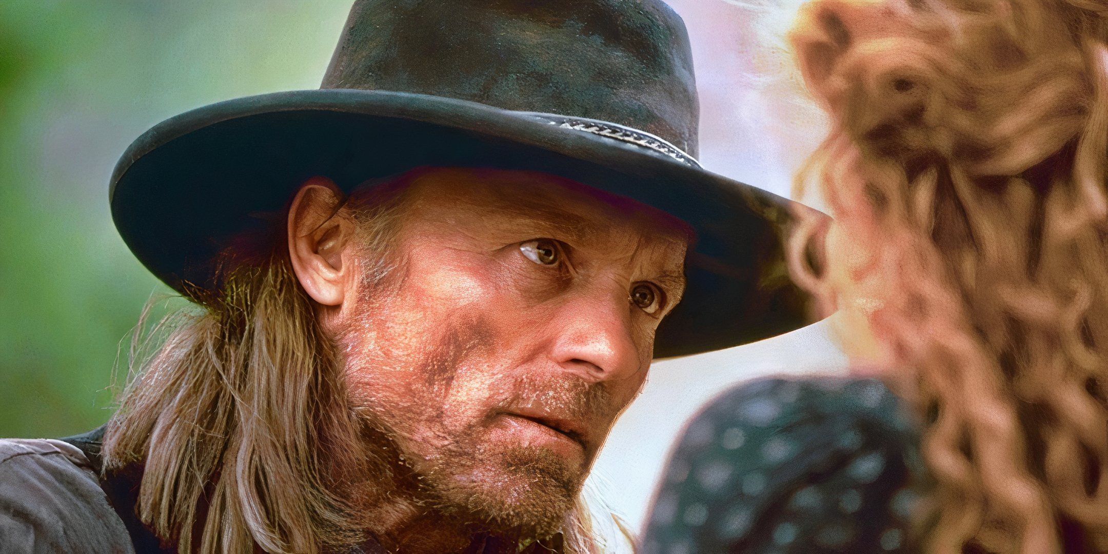 Ed Harris looks up at a woman with concern in Riders of the Purple Sage. 