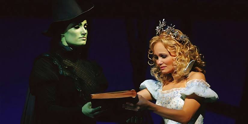 Elphaba (Idina Menzel) and Glinda (Kristin Chenoweth) examine the book of spells in Wicked