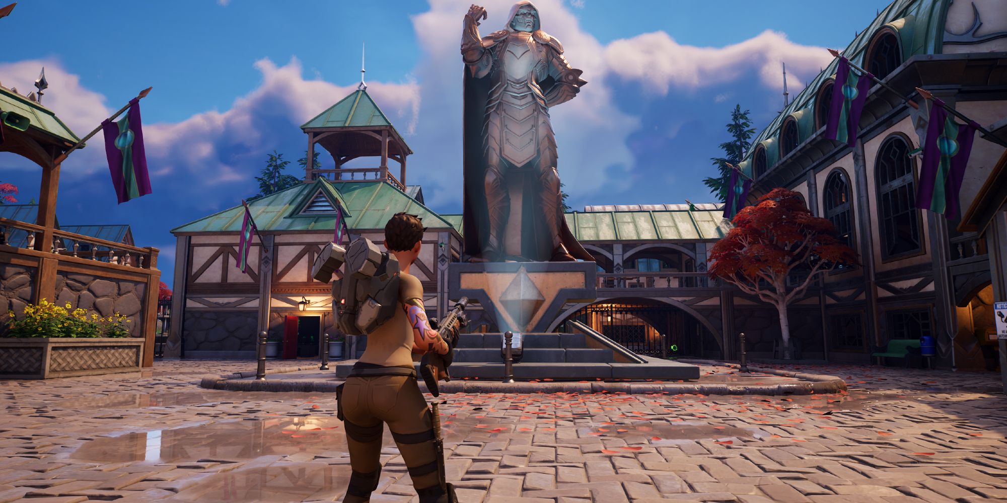 Female Character Holding Shotgun And Looking At Statue Of Doctor Doom In Doomstadt Town Square In Fortnite Chapter 5 Season 4