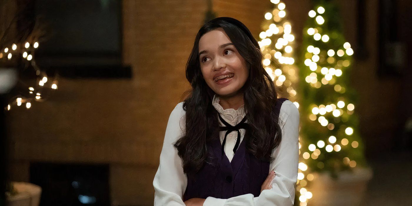 Sophia Hammons smiles in front of a Christmas tree