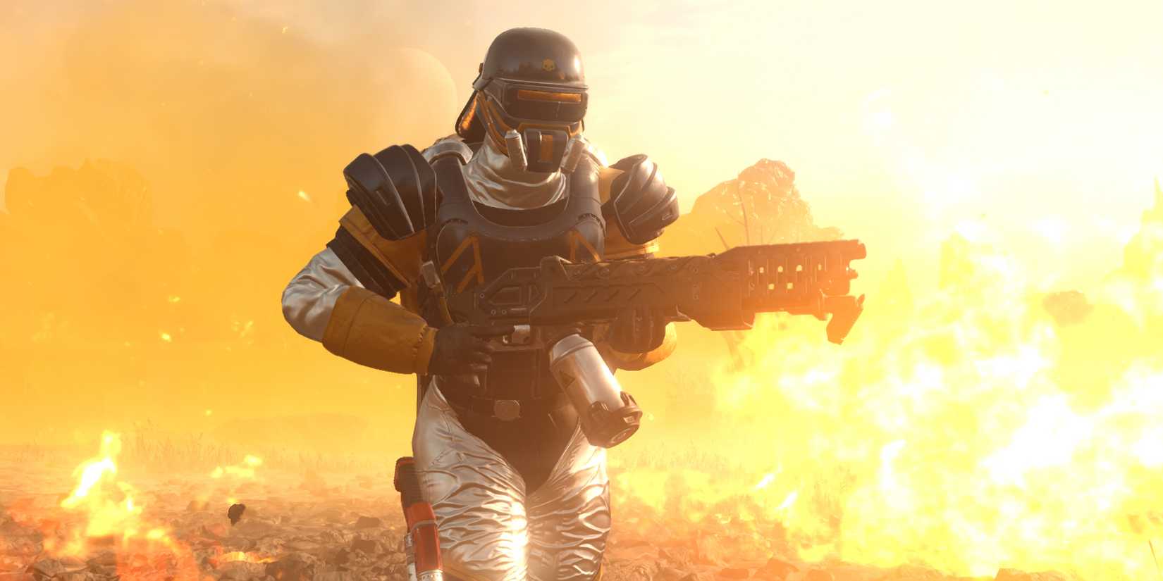 A Helldiver holding a flamethrower and running through a battlefield covered in fire.