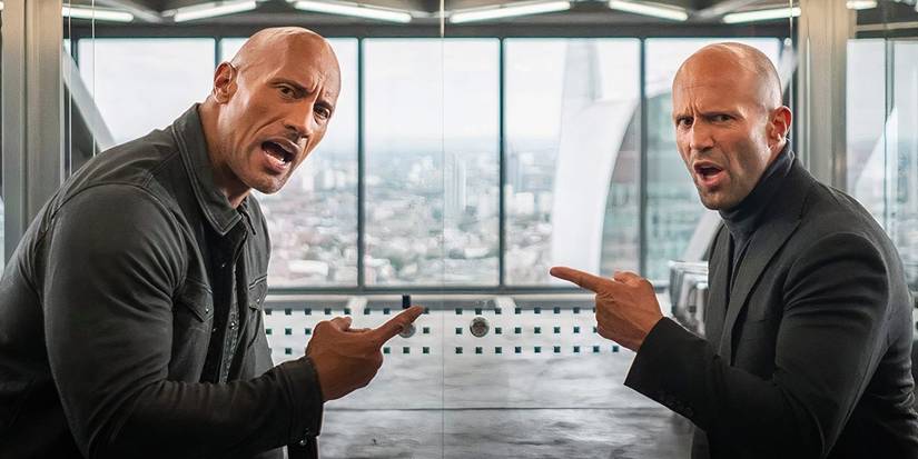 Dwayne Johnson and Jason Statham pointing at each other and yelling in Hobbs and Shaw