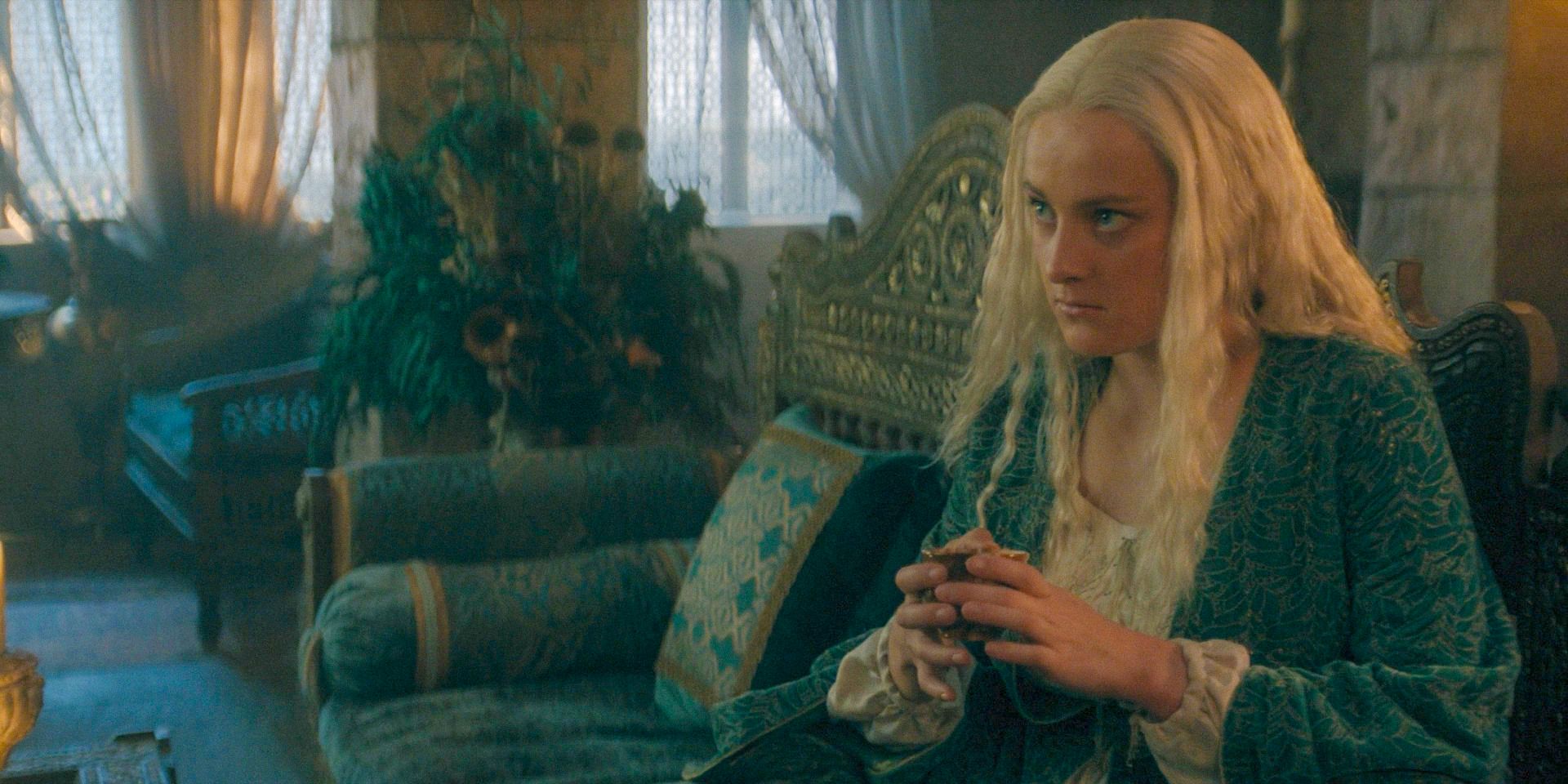 Helaena (Phia Saban) with an angry expression while drinking tea in Dragon House Season 2 Episode 8