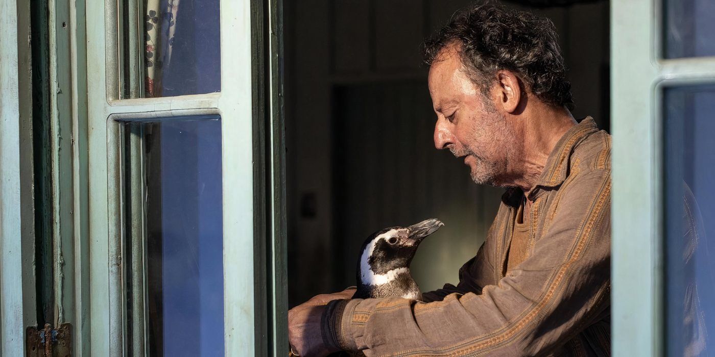 Jean Reno holds a penguin in My Penguin Friend