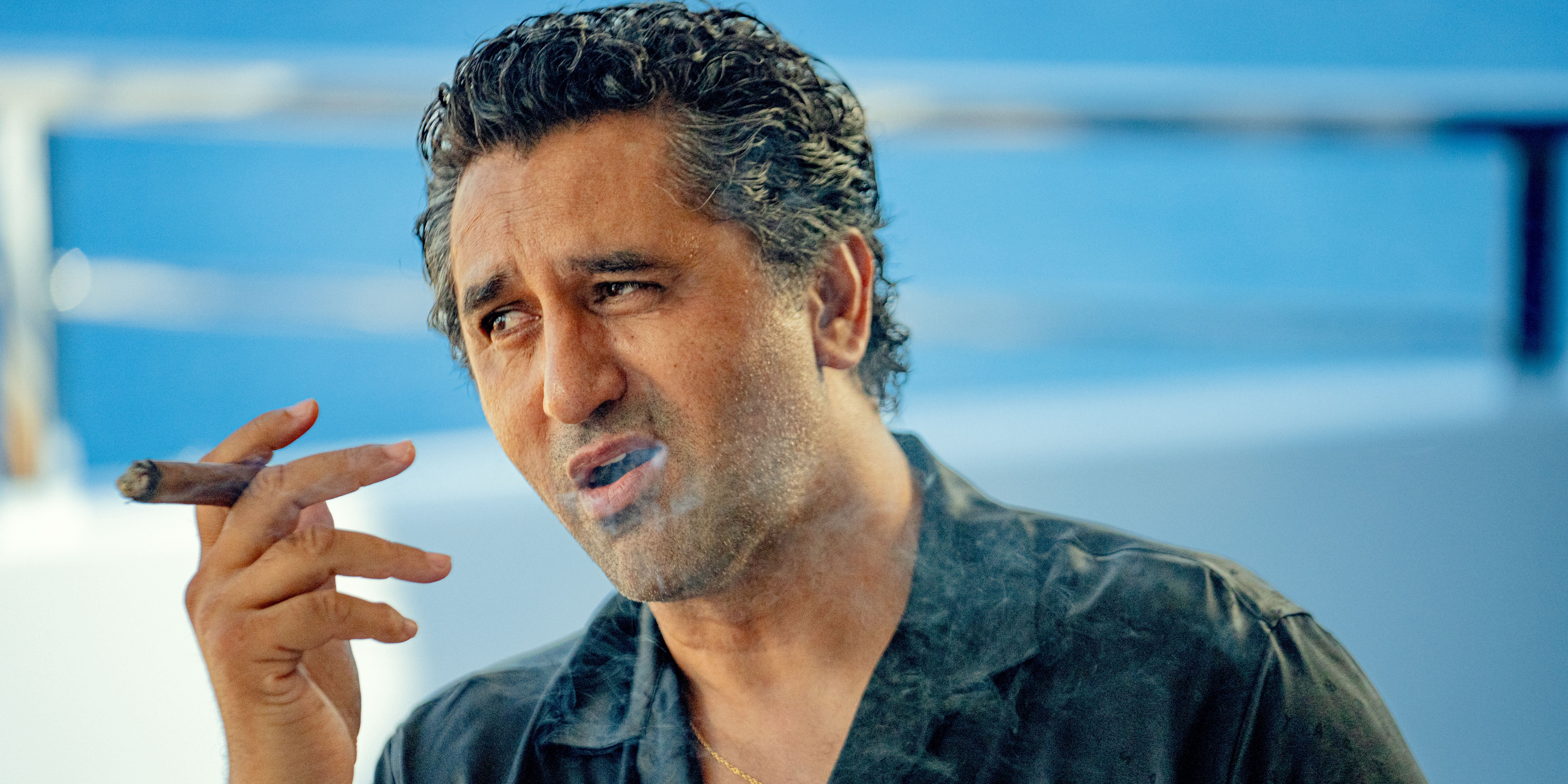 Poseidon (Cliff Curtis) smoking by the pool in KAOS Season 1