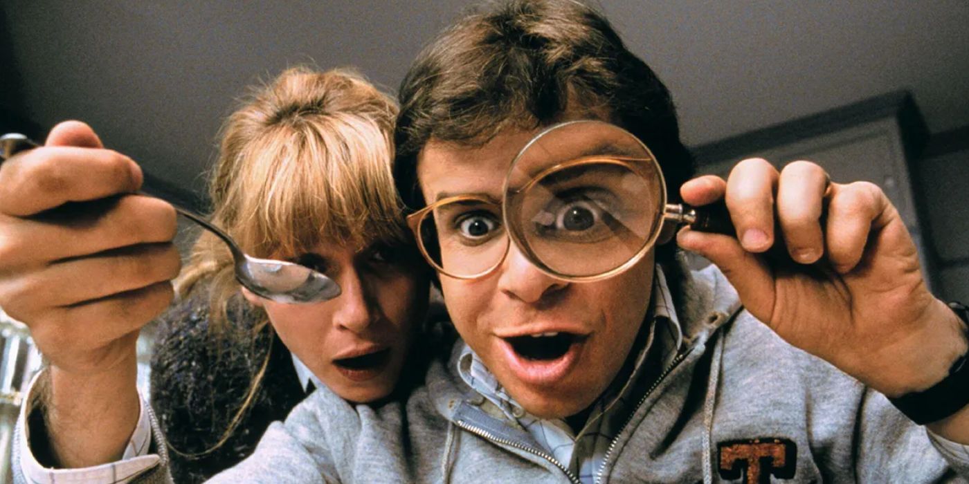 Wayne and Diane with a magnifying glass in Honey, I Shrunk The Kids