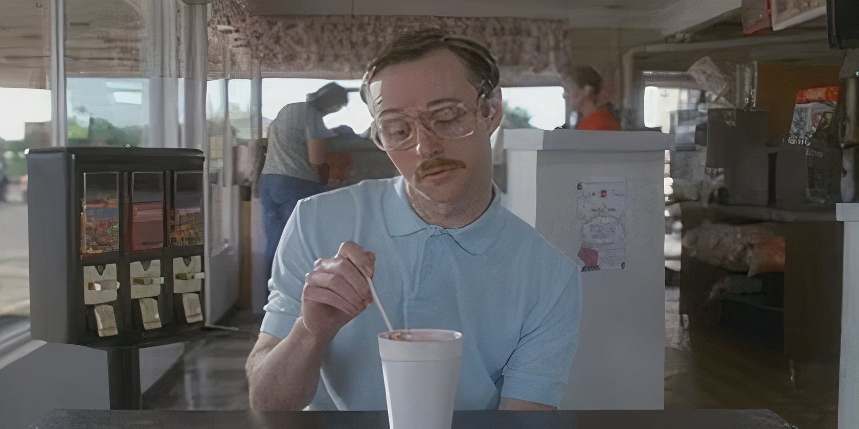 Kip sitting with a drink in a diner in Napoleon Dynamite