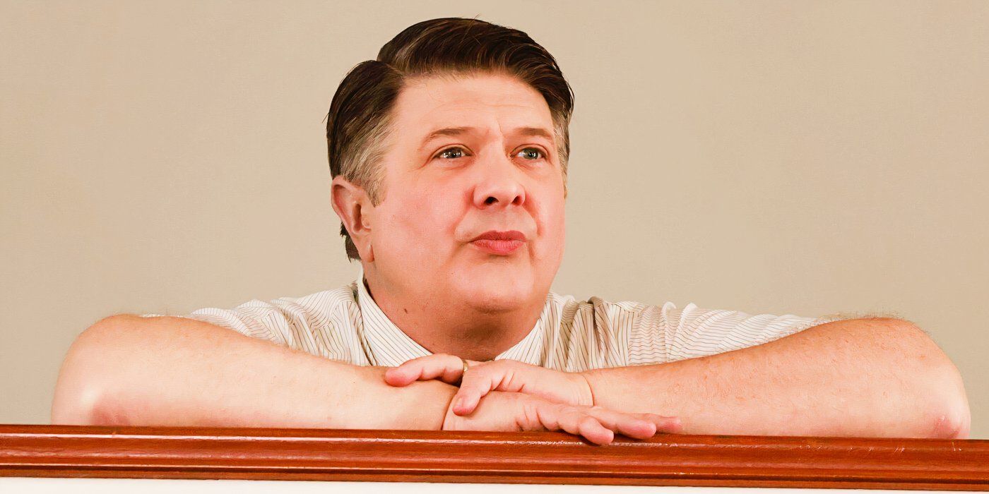 Lance Barber as George Sr. leaning on a railing and staring forward in Young Sheldon