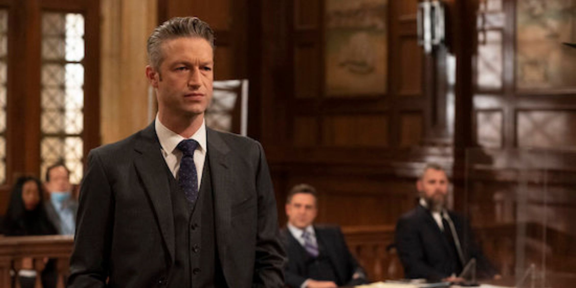 Law & Order SVU Carisi standing in the courtroom making a presentation