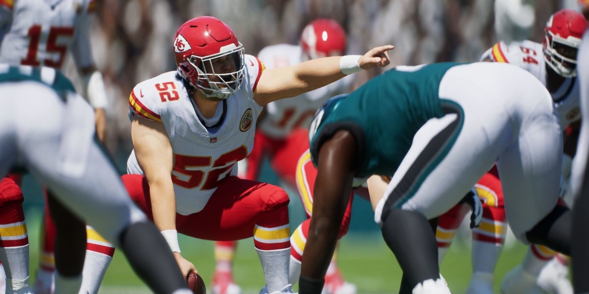 Centro do Kansas City Chiefs apontando um jogador de linha defensiva do Philadelphia Eagles.