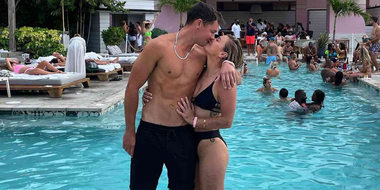 Malia White and Jake Baker from Below Deck Med smile for a picture together at the pool