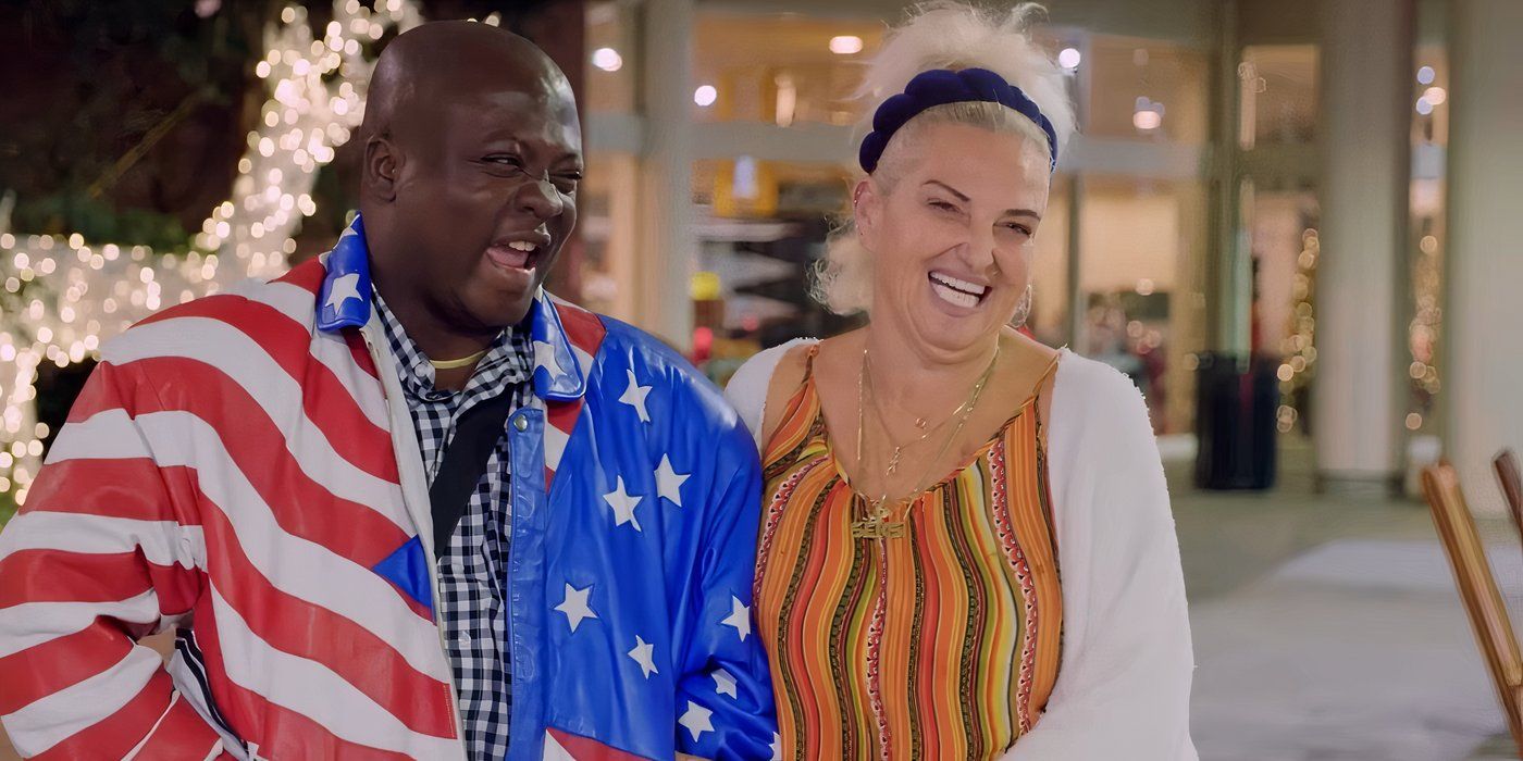 Michael Ilesanmi wearing American flag around himself and Angela Deem smiling at airport in 90 Day Faince