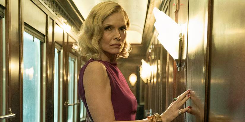 Michelle Pfeiffer touches a door in Murder on the Orient Express