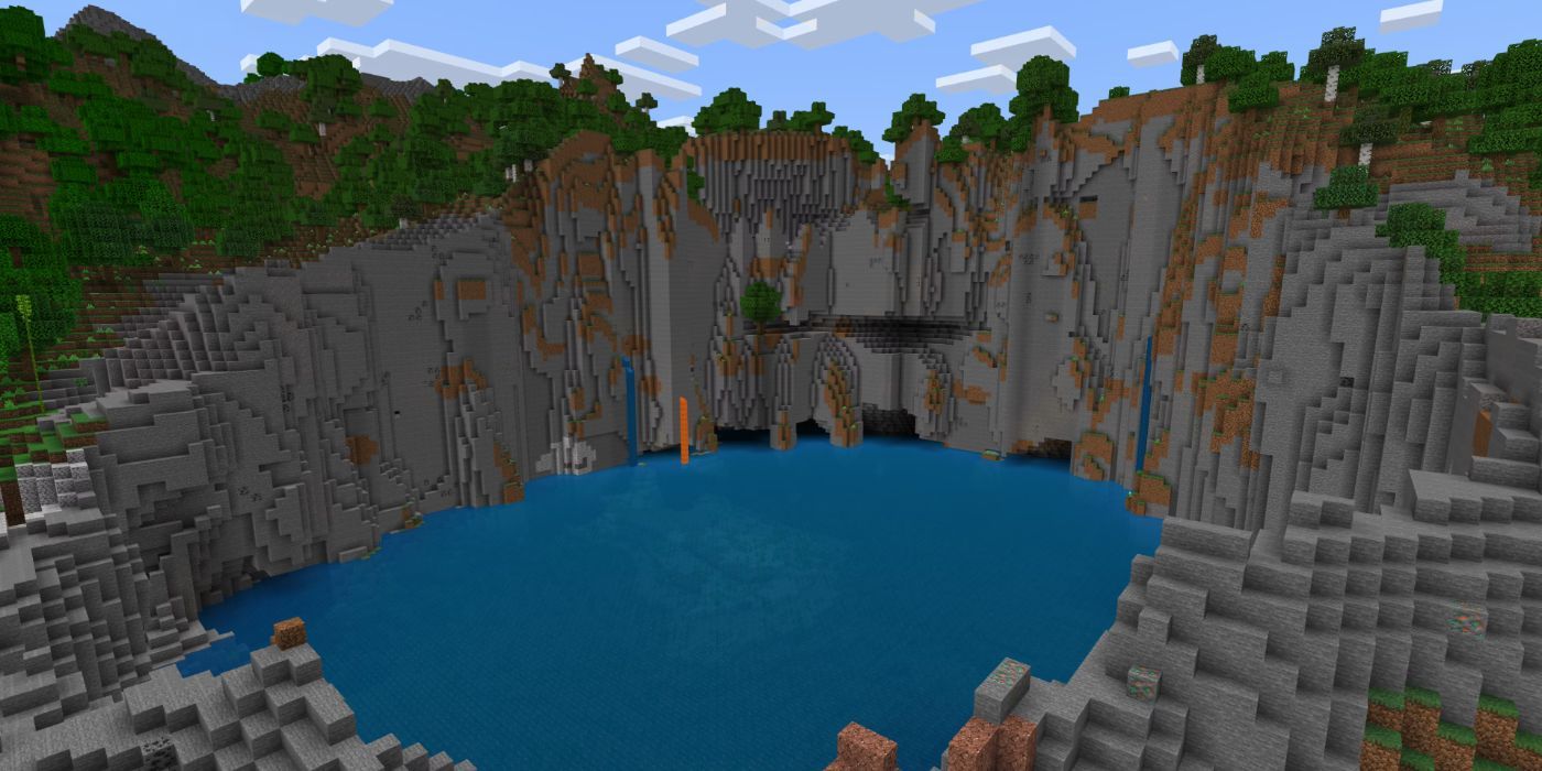 Minecraft Blue Lake Ringed By Grey Stone Hills with a small lava waterfall.