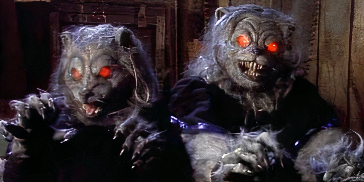 Two werewolves with glowing red eyes hold their arms out in front of them. 