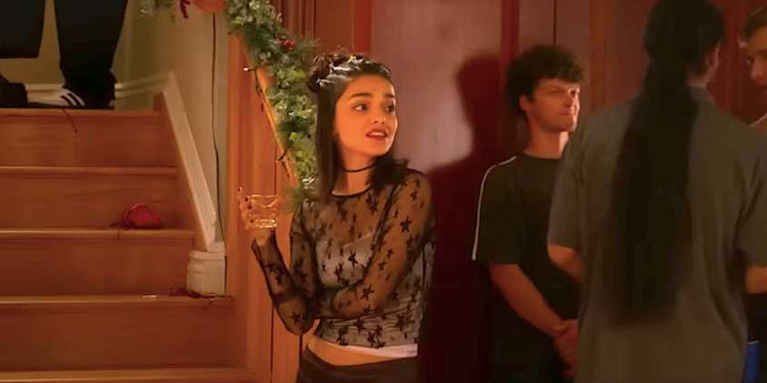 Rachel Zegler's Laura stands alone at a party in Y2K trailer