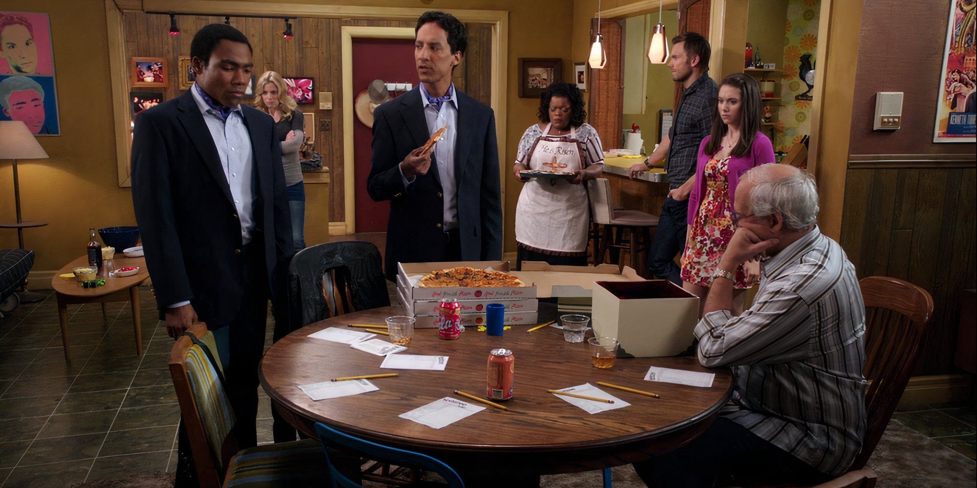 Troy, Britta, Abed, Pierce, Jeff, Shirley and Annie stood around the apartment in the Community episode Remedial Chaos Theory.