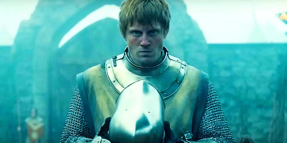 ser duncan holding his helmet while staring forward in a knight of the seven kingdoms