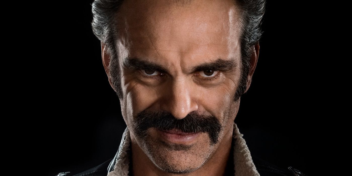 Simon (Steven Ogg) smiling sinisterly in The Walking Dead Dead City.