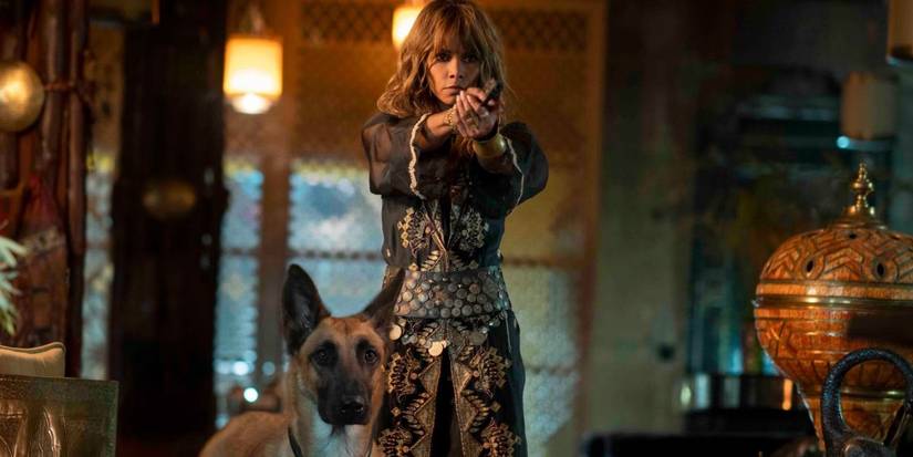 Sofia aiming a gun with her dog in John Wick 3