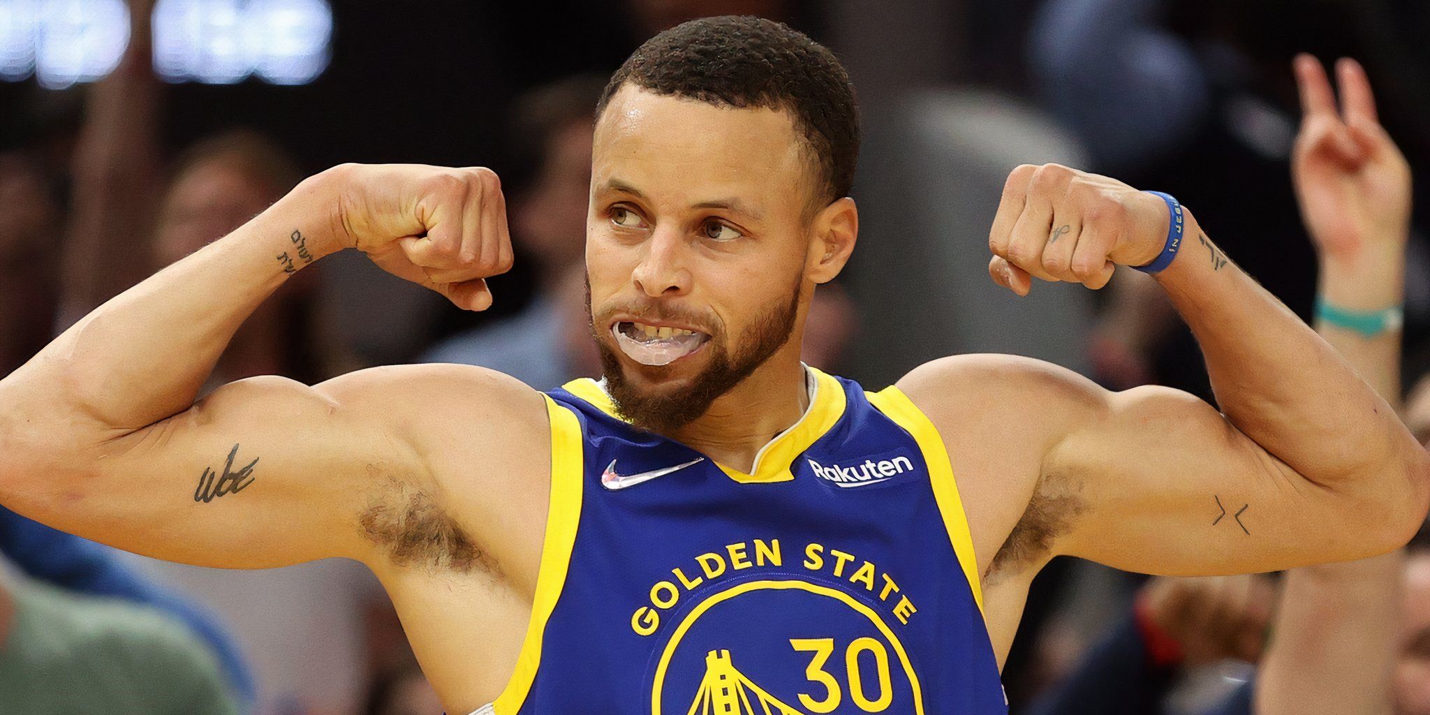 Stephen Curry flexing at a Golden State Warriors game